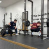 jarret beck coaches a lifter in the squat